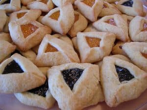 An picture of delicious looking Hamentashen. They appear to be blackberry and apricot flavored.