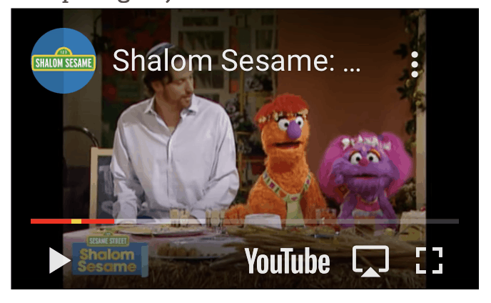 A screenshot of a youtube video from Shalom sesame, where two sesame street characters help a man cook food for shavuot.