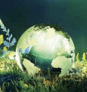 A screenshot of an image of the earth, illuminated, resting in a field of grass against a dark background.