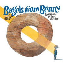 Illustrated book cover for Bagels from Benny. A giant bagel takes up most of the image, with a beam of light shining through the hole diagnonally and landing on a small child.
