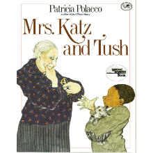 The illustrated book cover of Mrs. Katz and Tush. A young black boy holds a cat while talking with an older white woman.