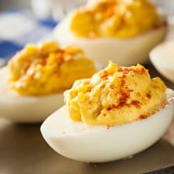 Four deviled eggs dusted with paprika